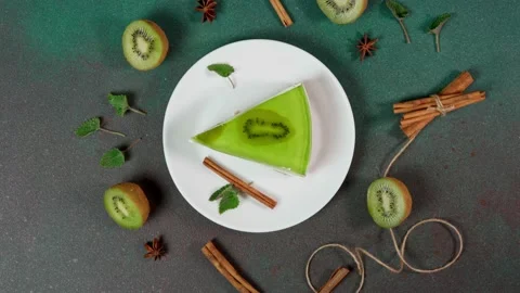 Slice Cheesecake with Kiwi. Decorated with slice of kiwi. Top view Stock Footage 236412821