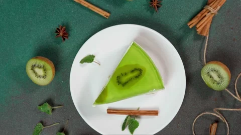 Slice Cheesecake with Kiwi. Decorated with slice of kiwi. Top view Stock Footage 236412833