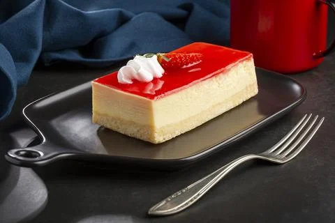 Slice of cheesecake with strawberry topping. Stock Photos