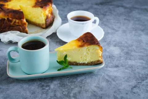 Slice of cheesecake with two cups of coffee. Copy space. Stock Photos