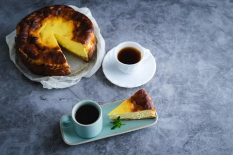 Slice of cheesecake with two cups of coffee. Copy space. Stock Photos