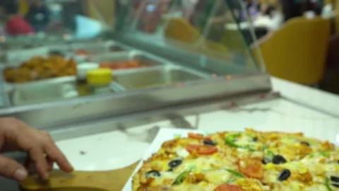 A slice of cheesy pepperoni pizza being served. Slow motion Stock Footage 243337910