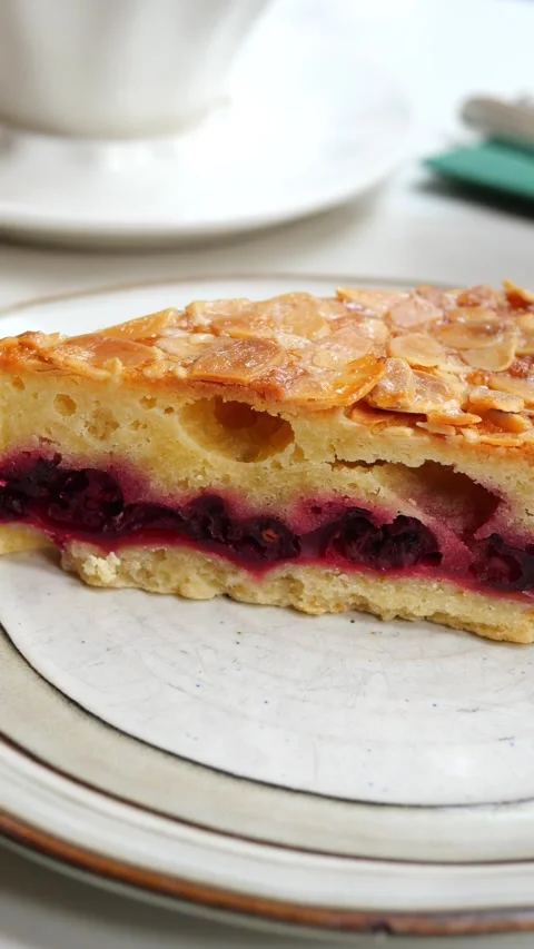 A Slice of Cherry Almond Cake on a Plate Stock Footage 338217131