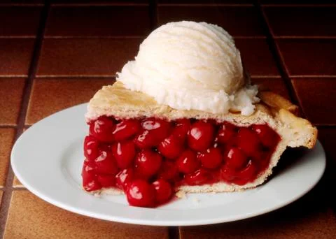 Slice of Cherry Pie with a Scoop of Vanilla Ice Cream Stock Photos