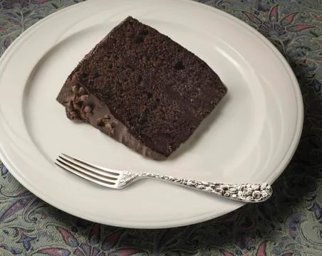 Slice of chocolate cake with silver fork Stock Photos