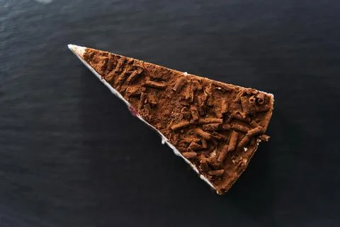 A slice of chocolate chip cake on a black tray Stock Photos