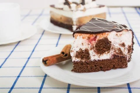 Slice of chocolate sponge cake with a cherry and air souffle cov Stock Photos