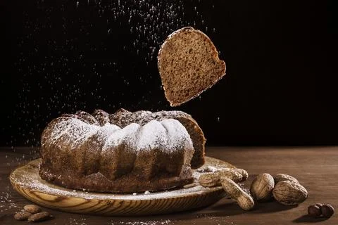 Slice of chocolate sponge cake that flies out of the rest of the sponge cake Stock Photos