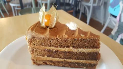 Slice of coffee cake with physalis Stock Photos