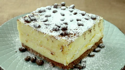 Slice of cream biscuit cake with butter cream decorated with chocolate candies. Stock Footage 234812997