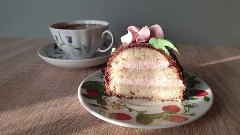 Slice of cream cake and a cup of tea. Stock Footage 118268599