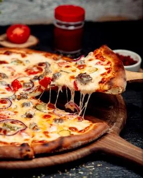 A slice of crispy pizza with meat and cheese Stock Photos