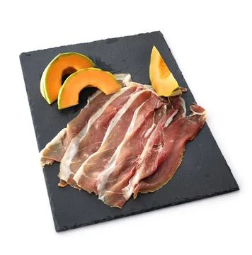 Slice of cured ham and melon Stock Photos