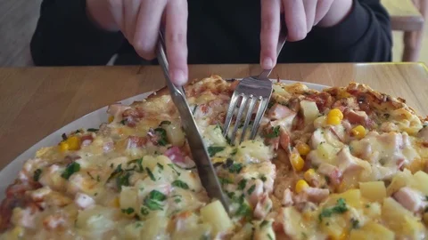 A slice is cut off from a big delicious pizza close-up Stock Footage 104778839