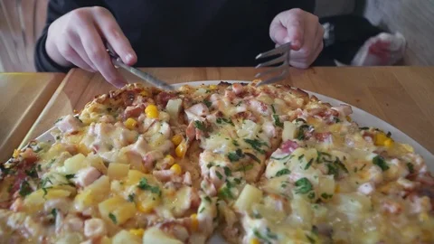 A slice is cut off from big delicious pizza Stock Footage 104779155