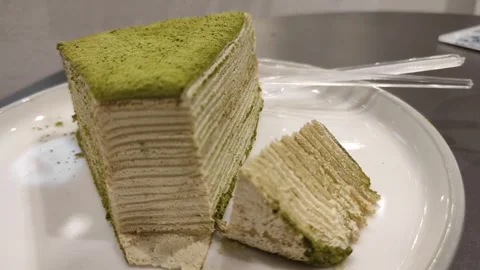 A slice of cut out matcha mille crepe Stock Footage 260538661