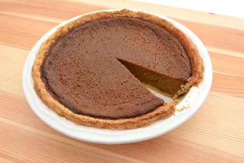 Slice cut from a pumpkin pie in a dish Stock Photos