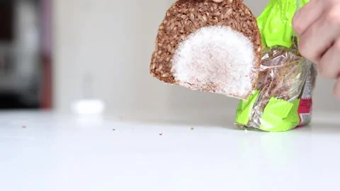 Slice of dark grain bread covered with visible mold is held in hand near an open Stock Footage 315940266