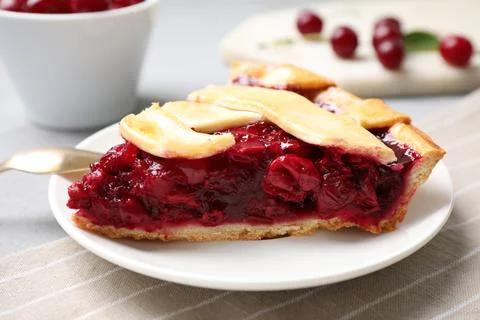 Slice of delicious fresh cherry pie on table, closeup Stock Photos