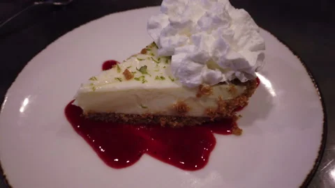 Slice of delicious fridge cake with berry coulis topping Stock Footage 157344212