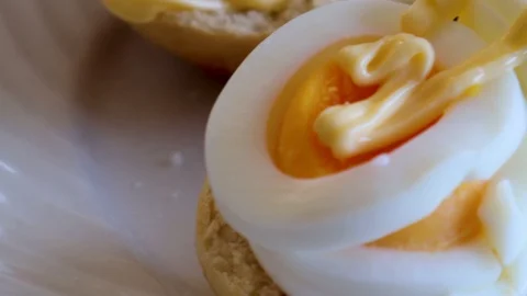 Slice of eggs and mayonnaise Stock Footage 122357549