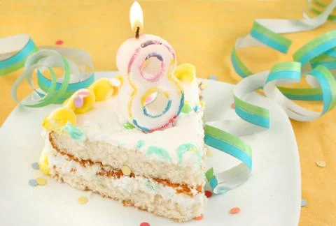 Slice of eighth birthday cake Stock Photos