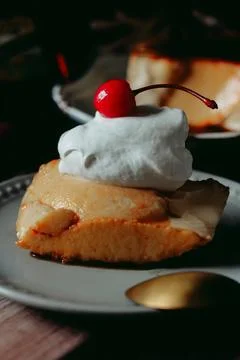 Slice of Flan Caramel Custard Pudding with Cream and Cherry Stock Photos