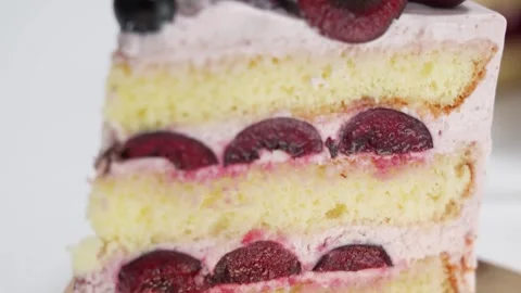Slice of Fresh Cherry and Blueberry Sponge Cake Stock Footage 343020761