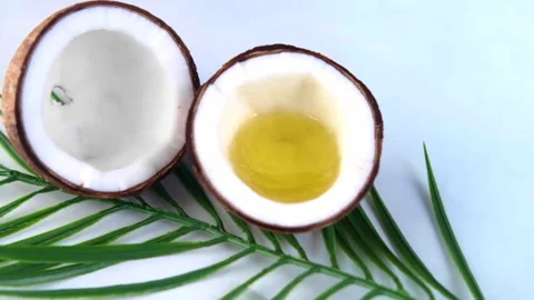 Slice of fresh coconut, oil and leaf on color background with copy space Stock Footage 158993689
