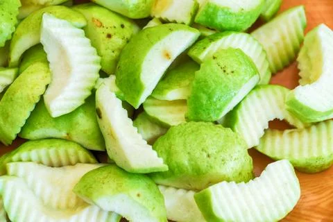 Slice of fresh guava fruit on Chopping board Stock Photos