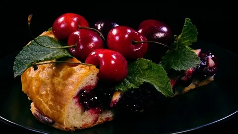 Slice of fresh homemade pie made from cherries and decorated with mint leaves 4K 動画素材 78284602
