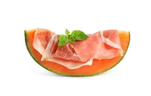 Slice of fresh melon with prosciutto and basil on white background Stock Photos