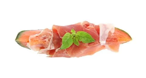Slice of fresh melon with prosciutto and basil on white background, top view Stock Photos