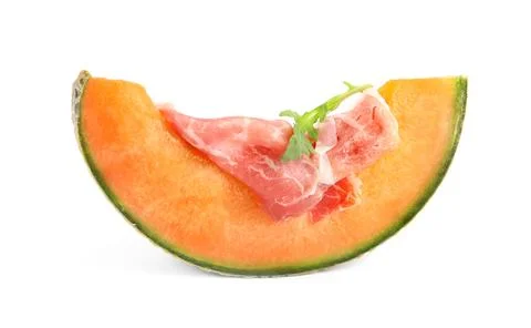 Slice of fresh melon with prosciutto and arugula on white background Stock Photos