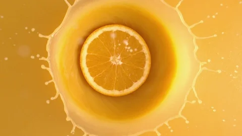 Slice of Fresh Orange Fruit Tossed into the Juice from Above Splattering 스톡 동영상 122128417