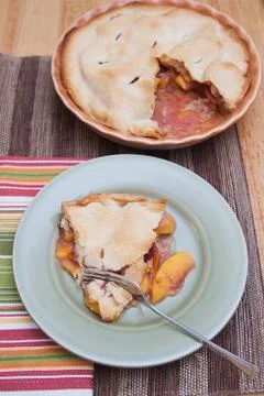 A slice of fresh peach pie Stock Photos