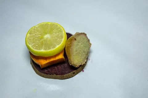 Slice of fresh raw turmeric, beetroot, lemon and ginger in studio on blurre.. Stock Photos