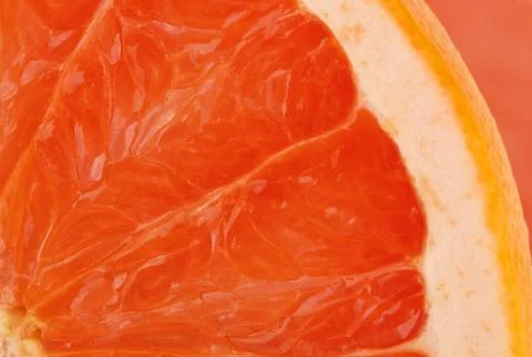 Slice of fresh red grapefruit Stock Photos