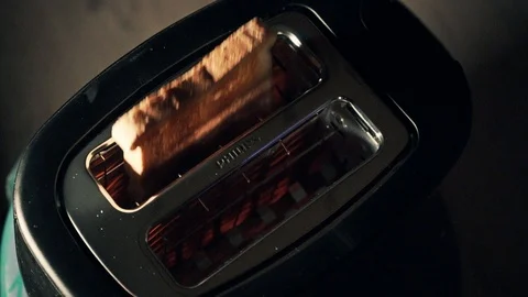 Slice of fresh toasted bread jumping out of the toaster. Stock Footage 111813036
