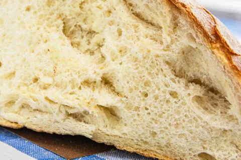 A slice of fresh white crunchy bread lies on the surface. Close-up Stock Photos