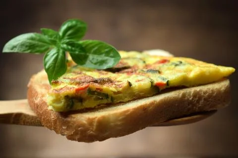 Slice of frittata with zucchini on bread Stock Photos