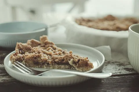 A slice of fruit crumble pie on a table Stock Photos