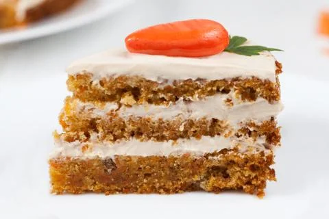 Slice of gourmet easter cake with cream and little orange carrot Stock Photos
