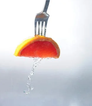 A slice of grapefruit on a fork Foto stock