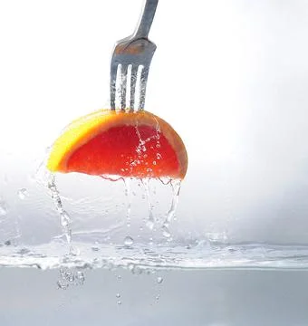 A slice of grapefruit on a fork Stock Photos