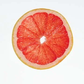 Slice of grapefruit isolated on white background Stock Photos