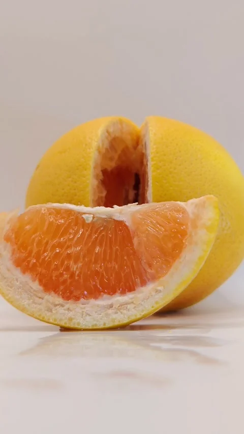 A slice of grapefruit on a white background Stock Footage 331746498
