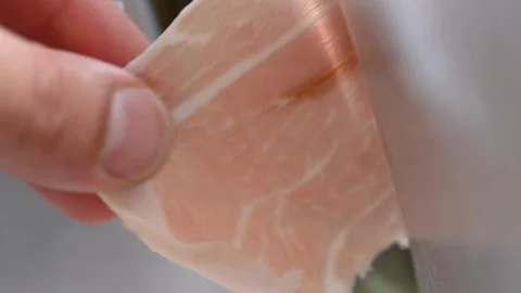 Slice of ham cut with a professional kitchen food slicer Stock Footage 119395868