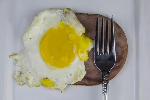 Slice of ham with a fried egg Stock Photos