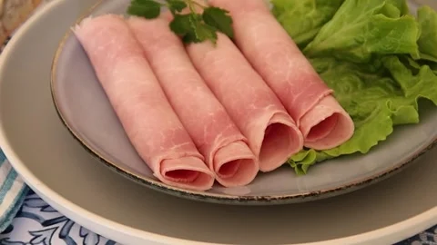 Slice of ham rolled in a dish on a table Stock Footage 171262840